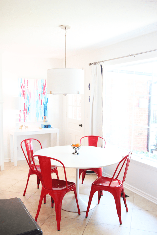all white kitchen with saarinen table and tolix chairs