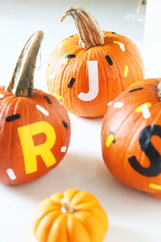 Custom monogrammed pumpkins with candy corn-inspired "sprinkles" - made with Cricut Explore - easy Halloween kid crafts - no mess craft - www.pencilshavingsstudio.com