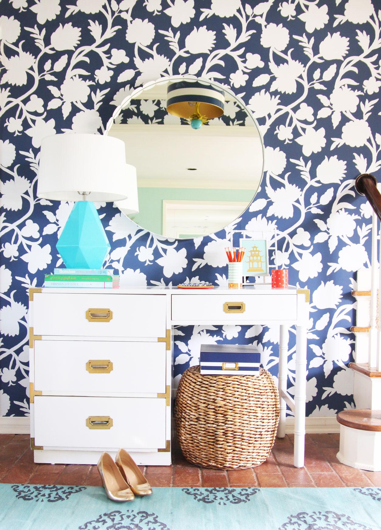 Entryway makeover with graphic floral wallpaper (Thibaut Cabrera in navy) at Pencil Shavings Studio. White campaign desk, Robert Abbey Delta lamp, Stray Dog Designs striped drum pendant www.pencilshavingsstudio.com