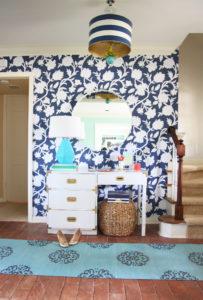 Entryway makeover with graphic floral wallpaper (Thibaut Cabrera in navy) at Pencil Shavings Studio. White campaign desk, Robert Abbey Delta lamp, Stray Dog Designs striped drum pendant www.pencilshavingsstudio.com