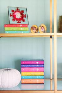 Decorating with colorful books and objects - styling bookshelves - www.pencilshavingsstudio.com