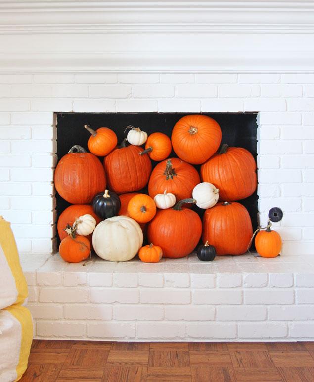fall mantel decoration with pumpkins - Pencil Shavings Studio - Colorful - Painted white brick mantel - lucite chairs - www.pencilshavingsstudio.com