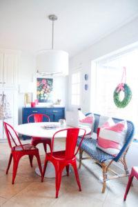 @psstudio Holiday House Tour breakfast nook - white kitchen - Serena & Lily Riviera bench - West Elm boxwood wreath - Sugar Paper ribbon - Hedgehouse throw stripe pillows - red Tolix chairs - www.pencilshavingsstudio.com