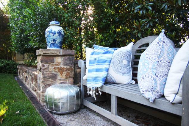 Poolside outdoor bench with blue and white textiles - blue and white ginger jars - www.pencilshavingsstudio.com