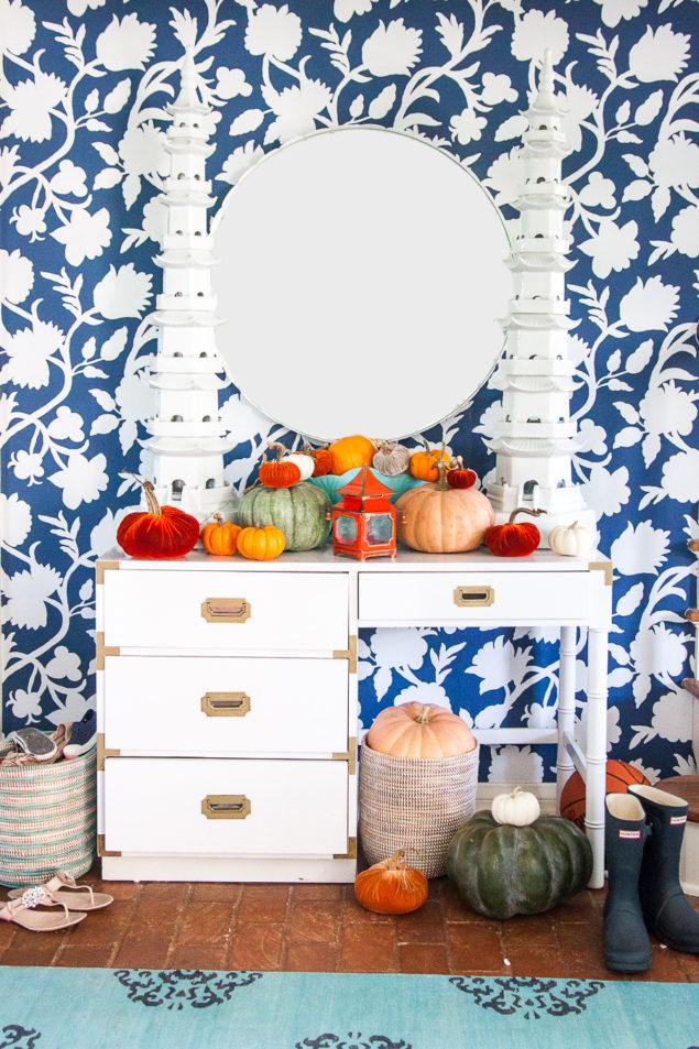 Bold fall decor with a Chinoiserie twist: our Thibaut wallpaper entryway in a silhouette floral is paired with a vintage white campaign desk and a pair of ceramic Bungalow 5 pagodas. For fall this year, I brought in a mix of white, green and traditional orange pumpkins along with a handful of velvet pumpkins too. www.pencilshavingsstudio.com