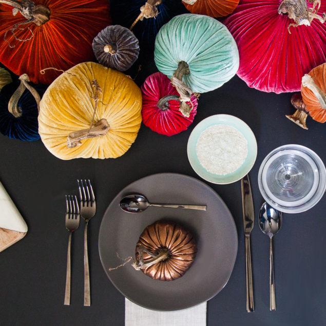A colorfully moody tabletop -- fall centerpiece ideas with velvet pumpkins, matte black dishes, copper accents and loads of style. www.pencilshavingsstudio.com