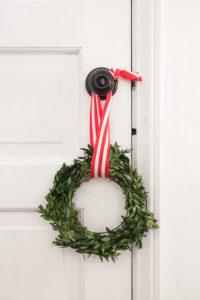 A simple and easy DIY for Christmas decor, this step by step guide will show you how to make this boxwood wreath. Simple, inexpensive, and a great Christmas craft for kids. See the full tutorial at www.pencilshavingsstudio.com
