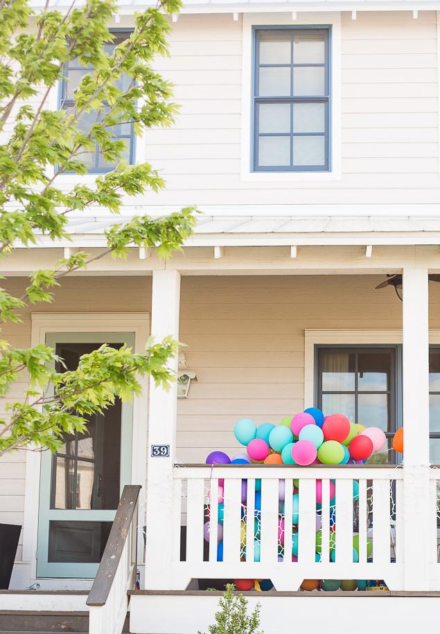 Brightly colored balloons on a modern farmhouse porch - like the house in Up with all the balloons. www.pencilshavingsstudio.com