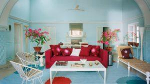 Bold and colorful lipstick red sofa in Jaipur apartment featured in Architectural Digest