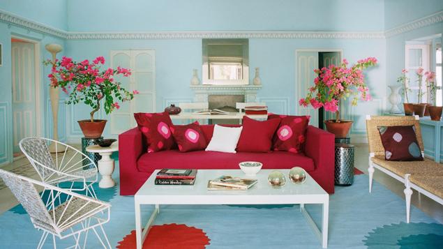 Bold and colorful lipstick red sofa in Jaipur apartment featured in Architectural Digest